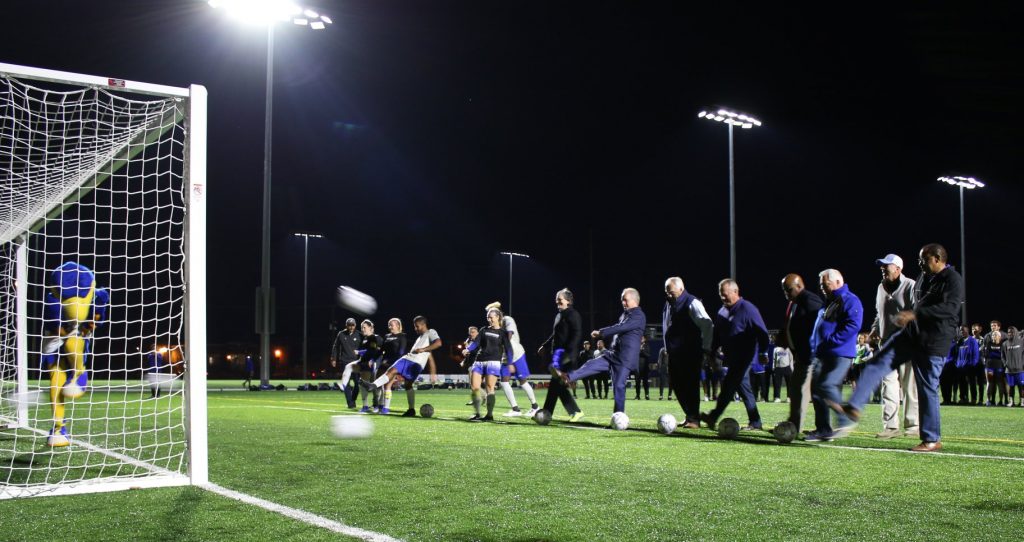 The ceremonial 'First Kick' of Spalding students, administrators, donors and trustees during the Oct. 23 grand opening